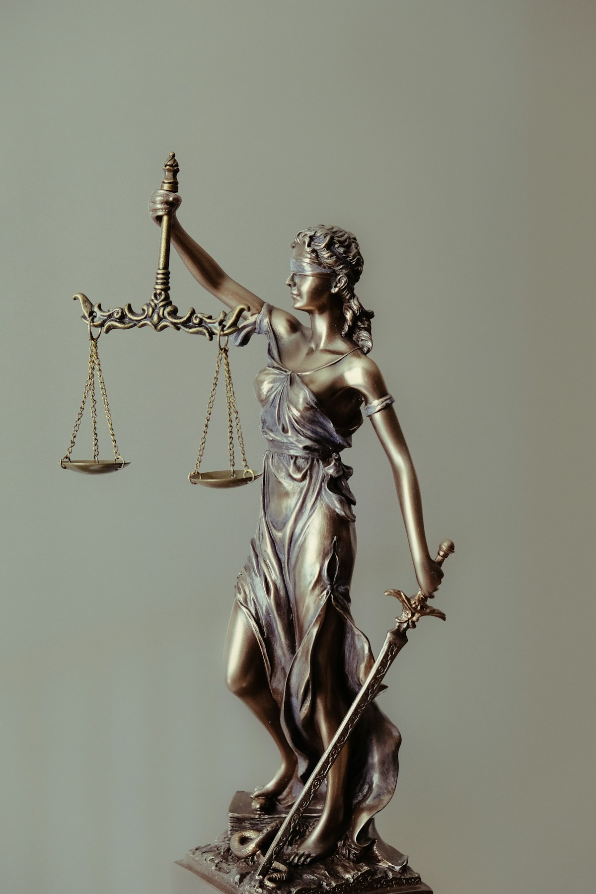 Lady Justice figurine representing Texas employment law and EEOC discrimination protections for workers