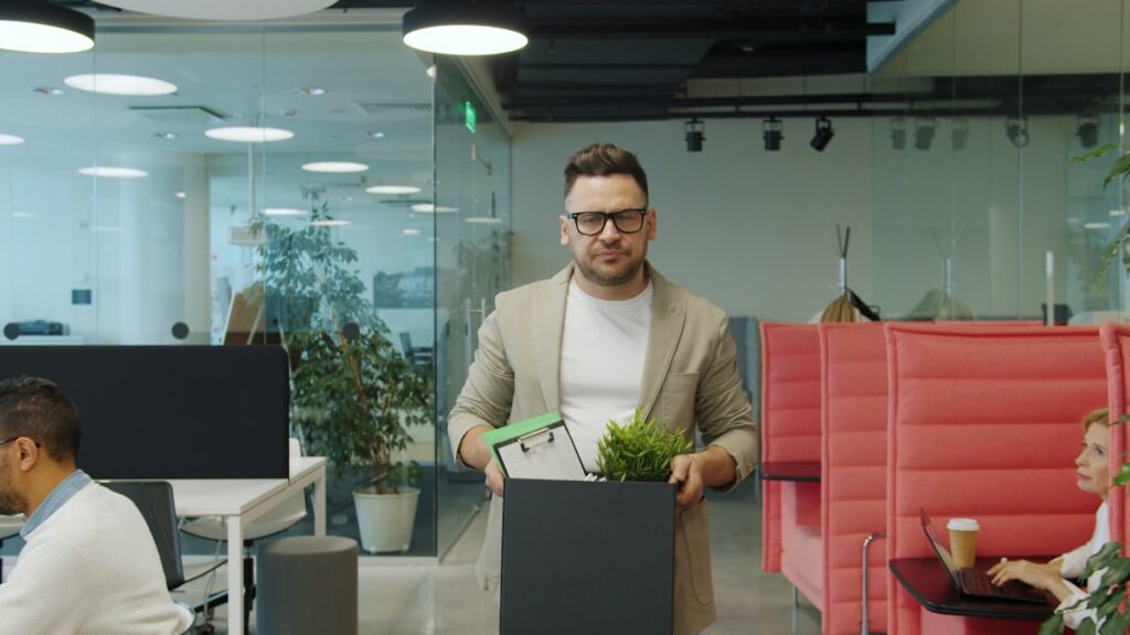 Employee carrying box of personal belongings after wrongful termination in Texas